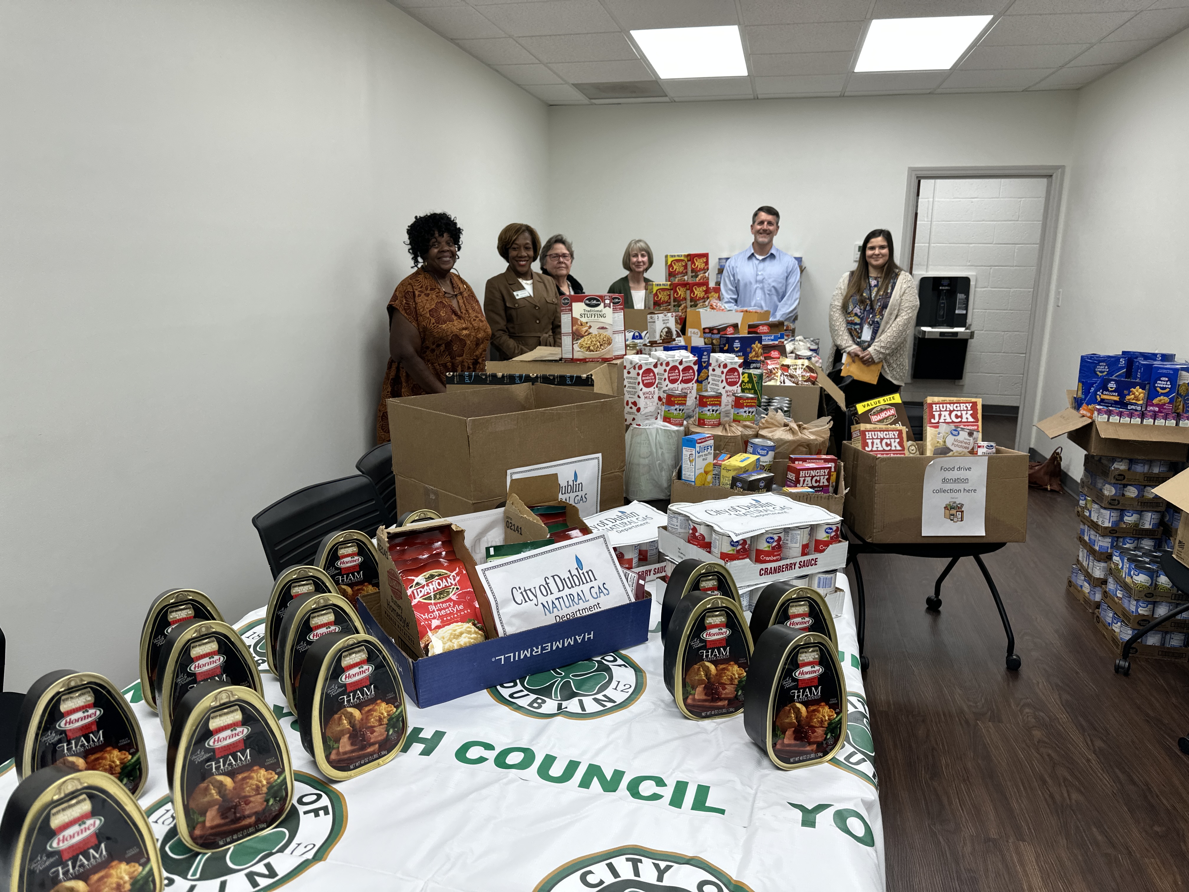 Group standing with donated food